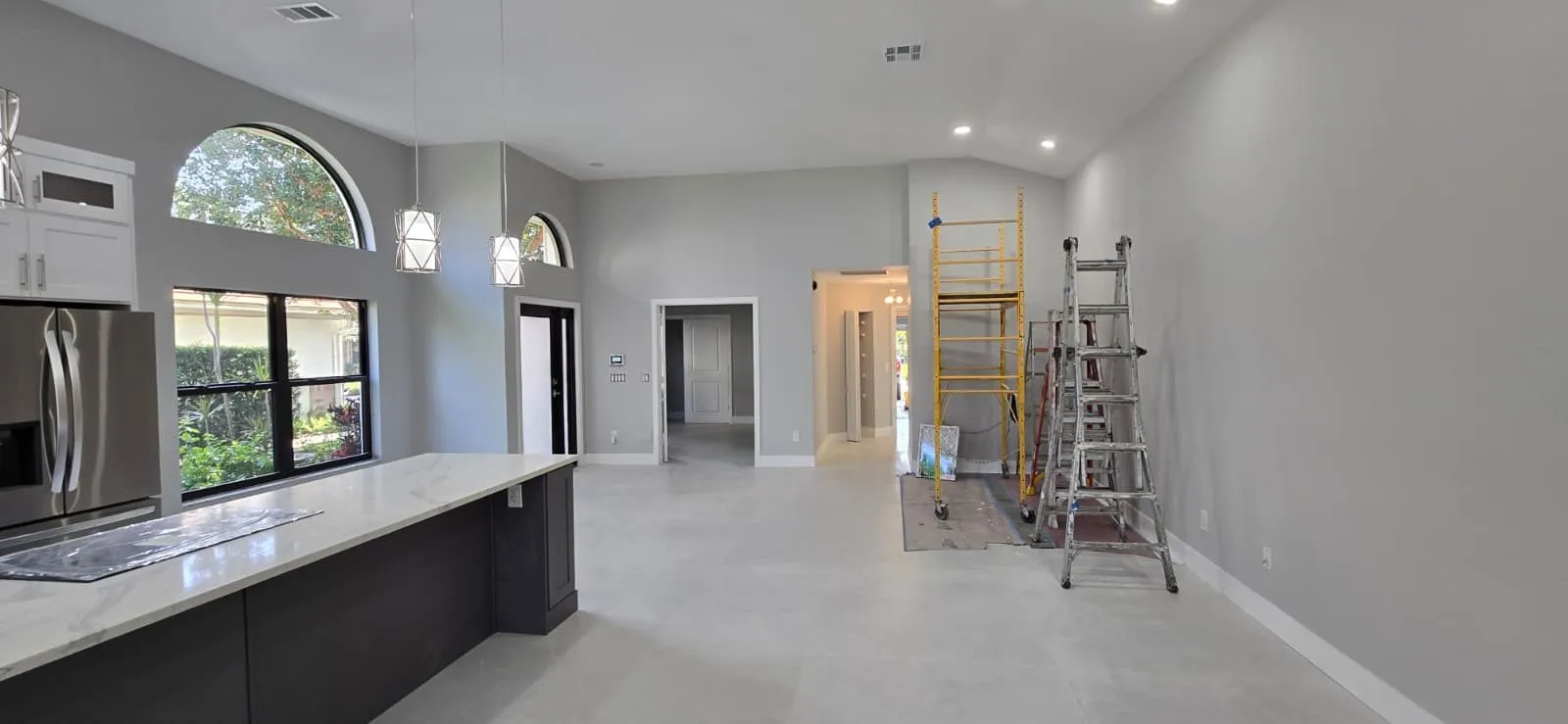 Open-plan kitchen during construction with ladders